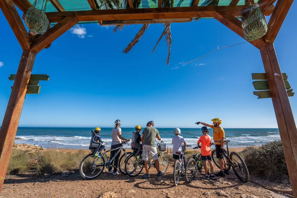 Family cycling by the sea on the Mar Menor shore